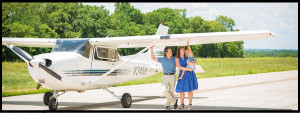 Family in front of airplane border